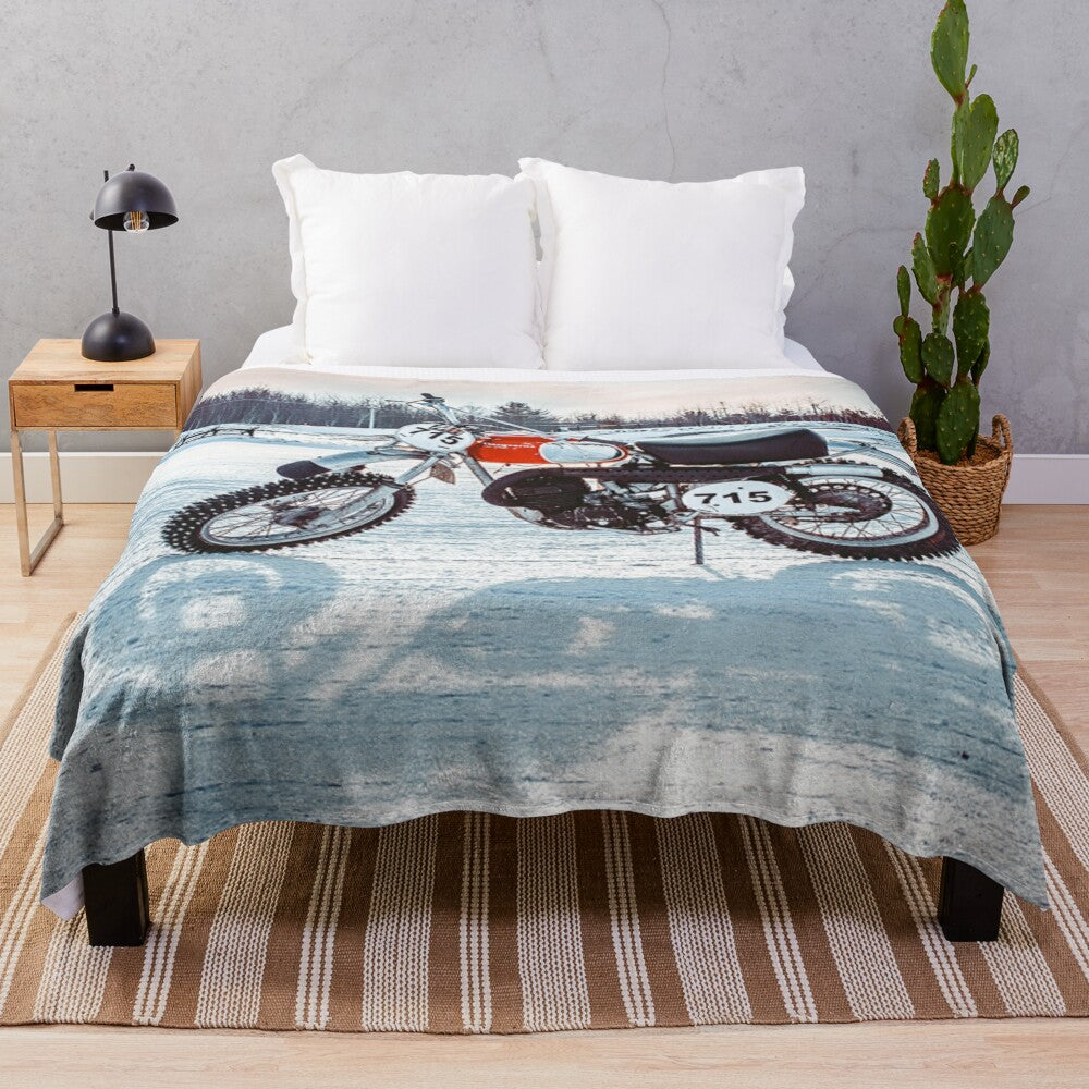 Plush blanket featuring a dirt bike riding on ice or snow