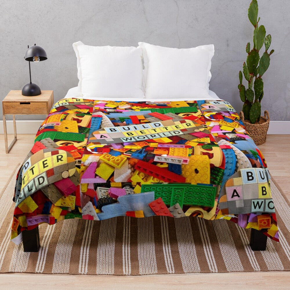 Lego-inspired plush blanket depicting the message "Build a Better World"