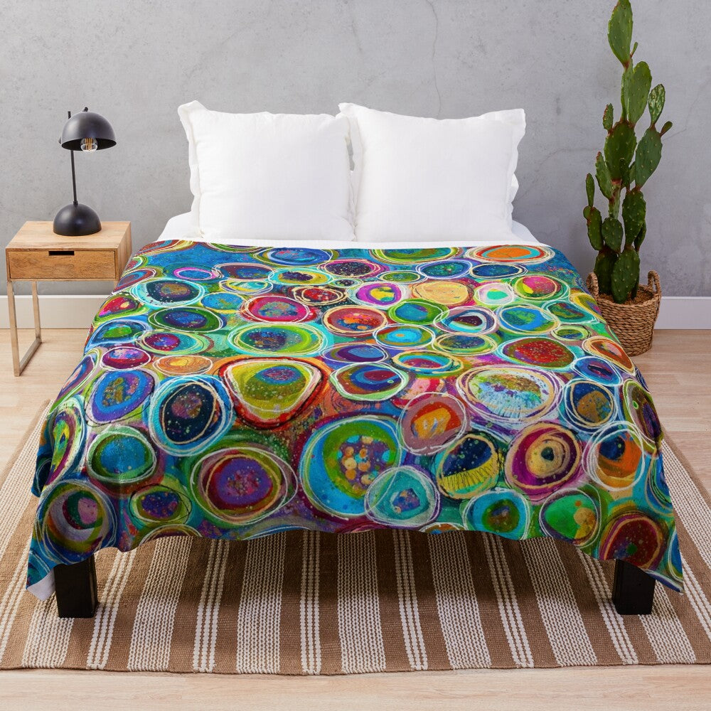 Vibrant abstract patterned plush blanket with geometric shapes and colorful design