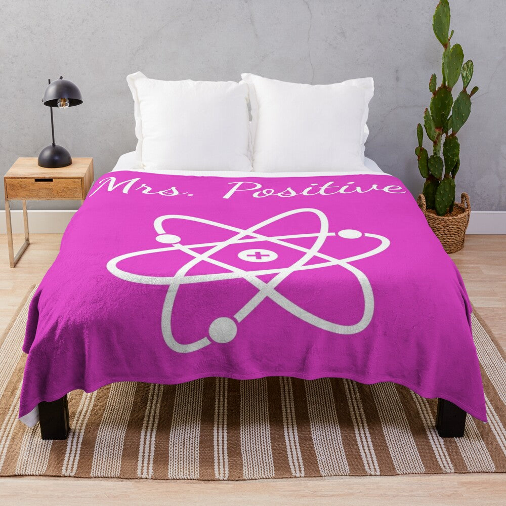 Plush blanket with atom design, science-themed home decor