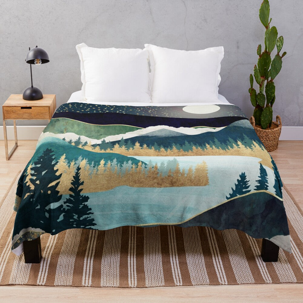 Plush blanket with a nature-inspired celestial design featuring stars, a mountain lake, and evergreen forest