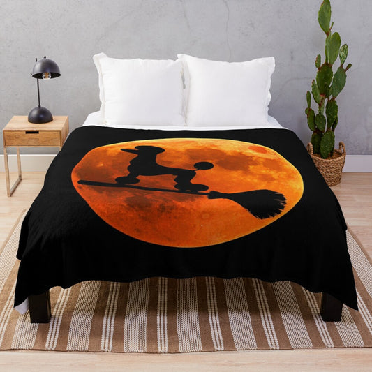 Poodle dog silhouette against the moon on a cozy plush blanket for Halloween