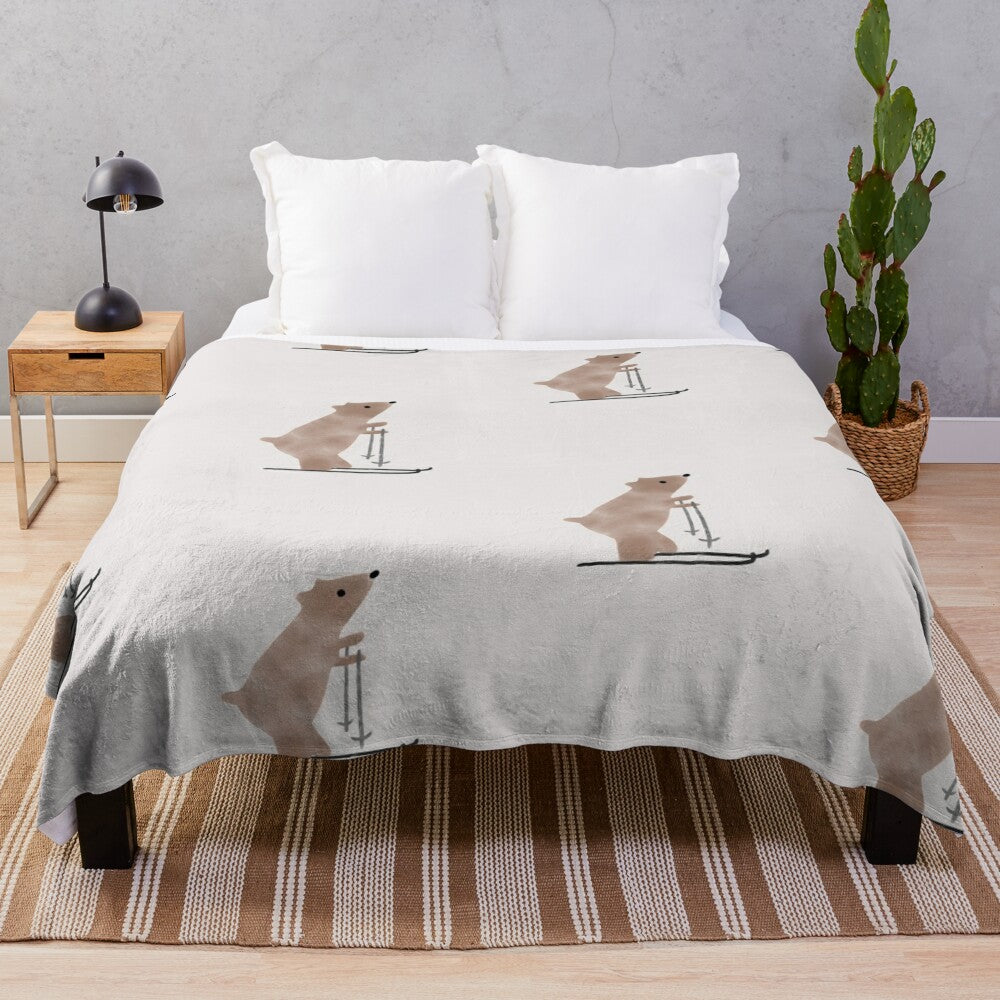 A whimsical plush blanket featuring a watercolor-style illustration of a bear on skis in a snowy, winter landscape