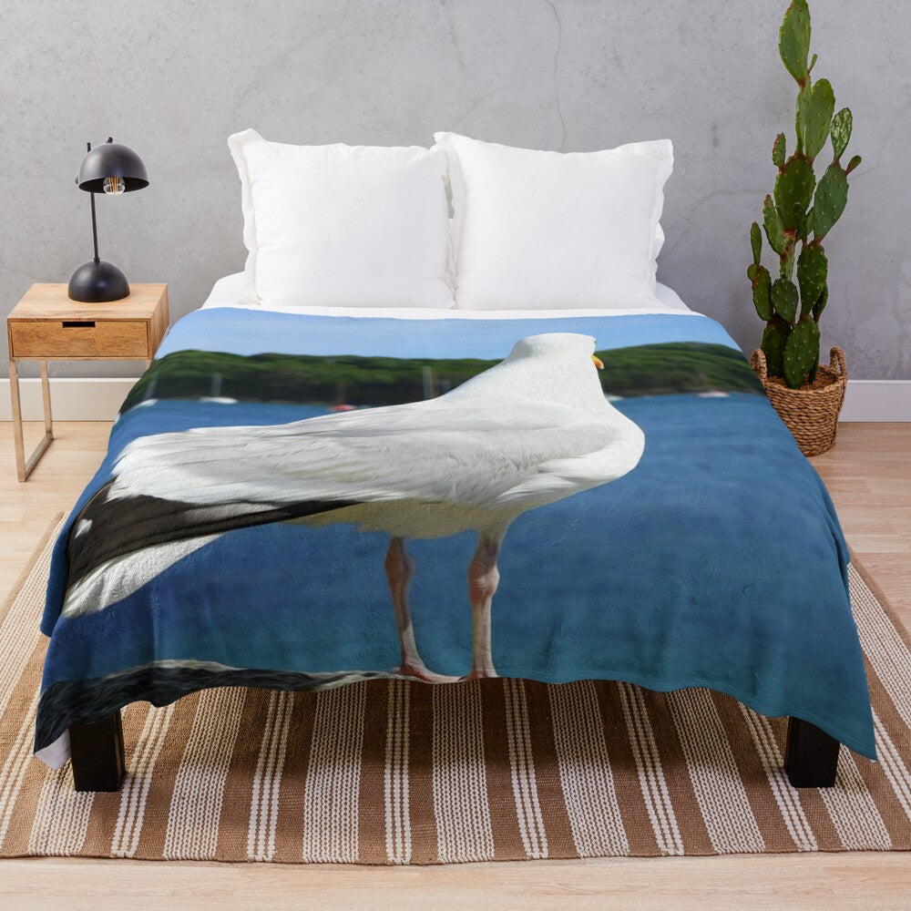 Plush blanket featuring a design of seagulls perched on a nature landscape