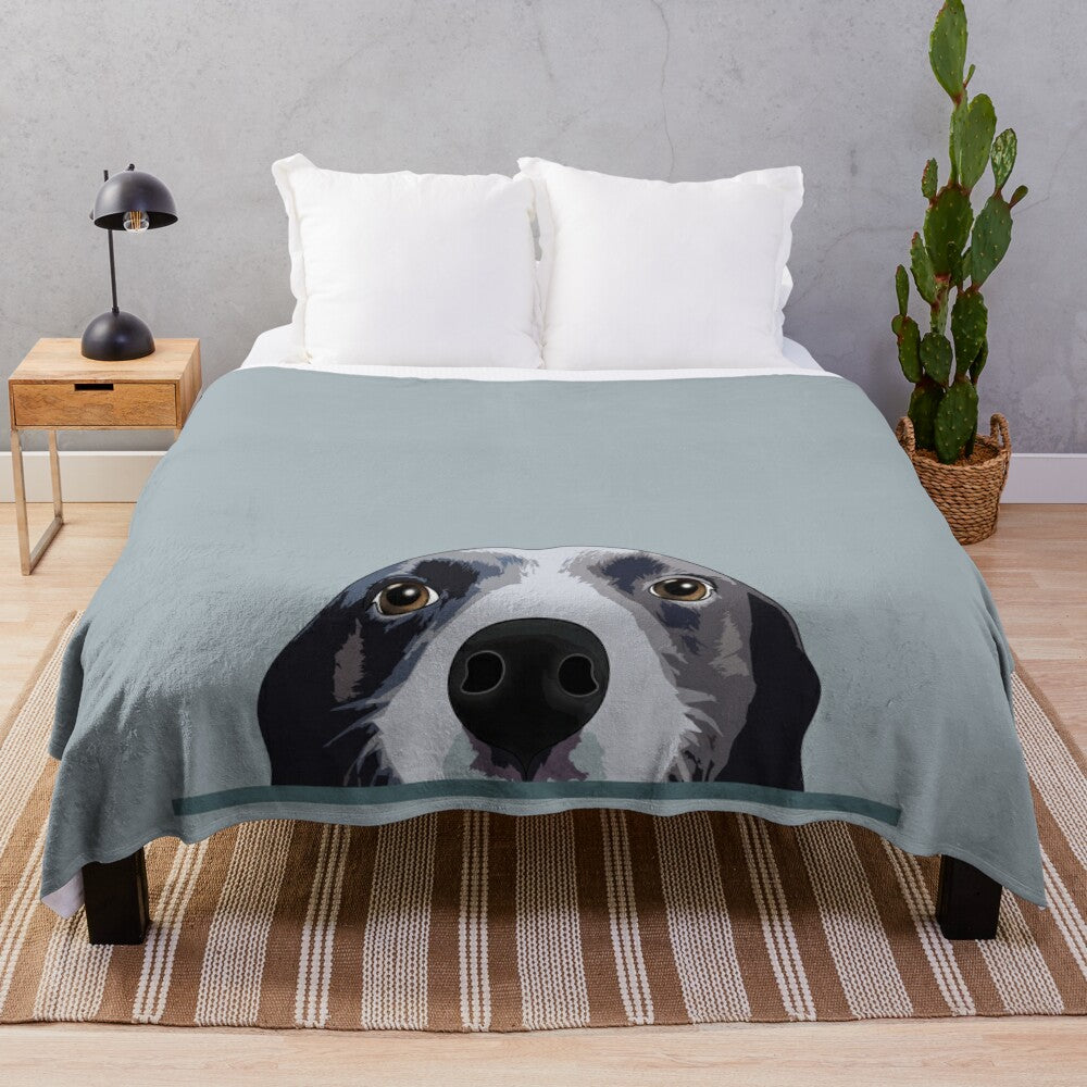 Cute border collie puppy peeking out from a cozy plush blanket