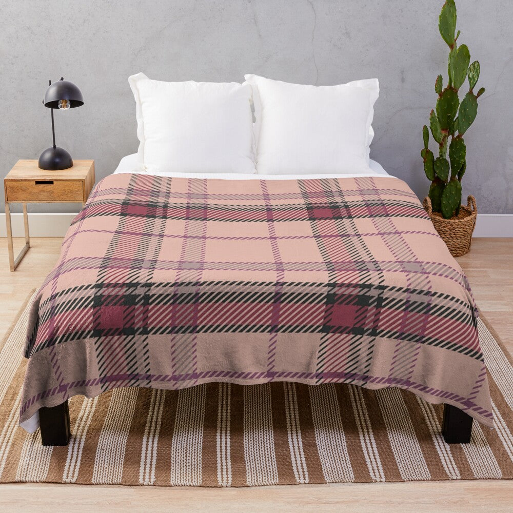 Plush tartan blanket featuring a classic Scottish pattern in pink and brown tones