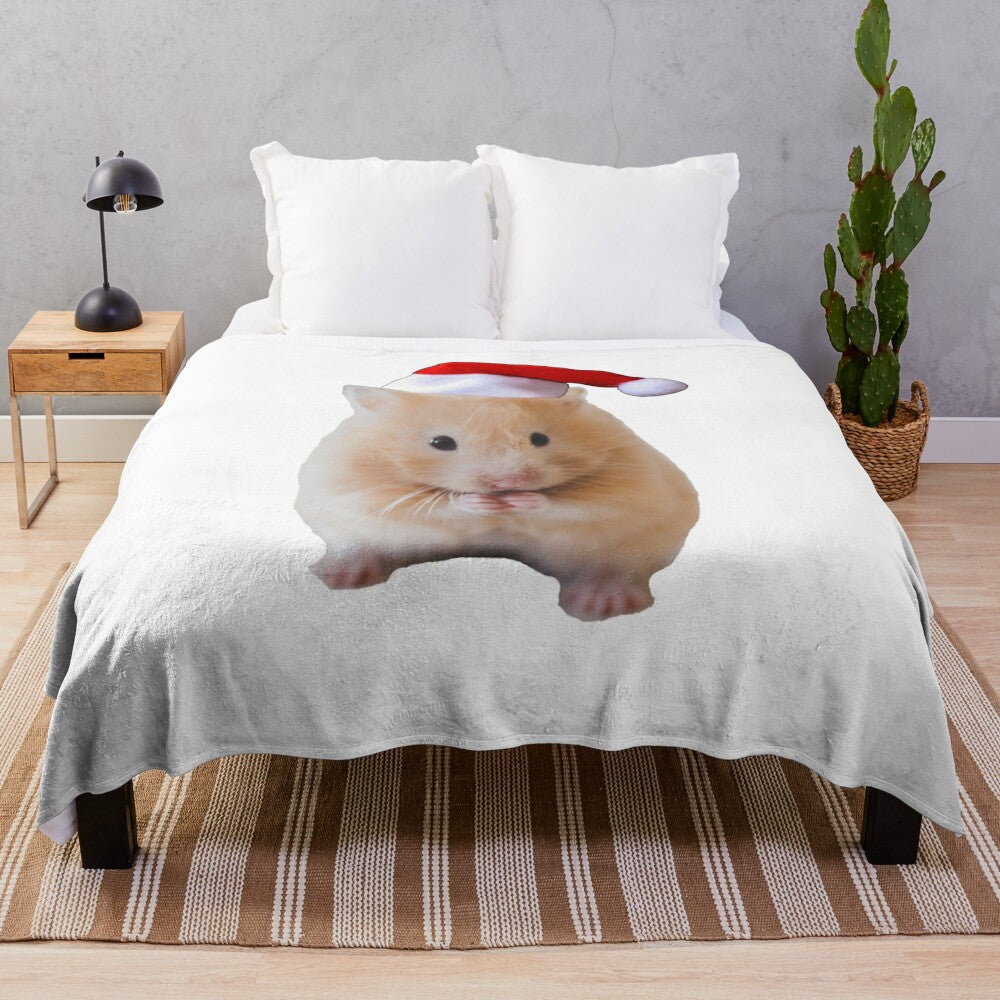 Cute hamster wearing a Christmas hat on a plush blanket