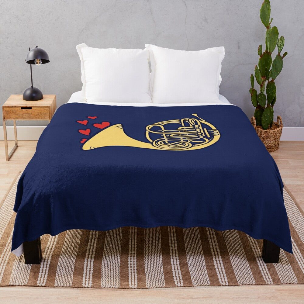 Plush blanket featuring a French horn design for music enthusiasts