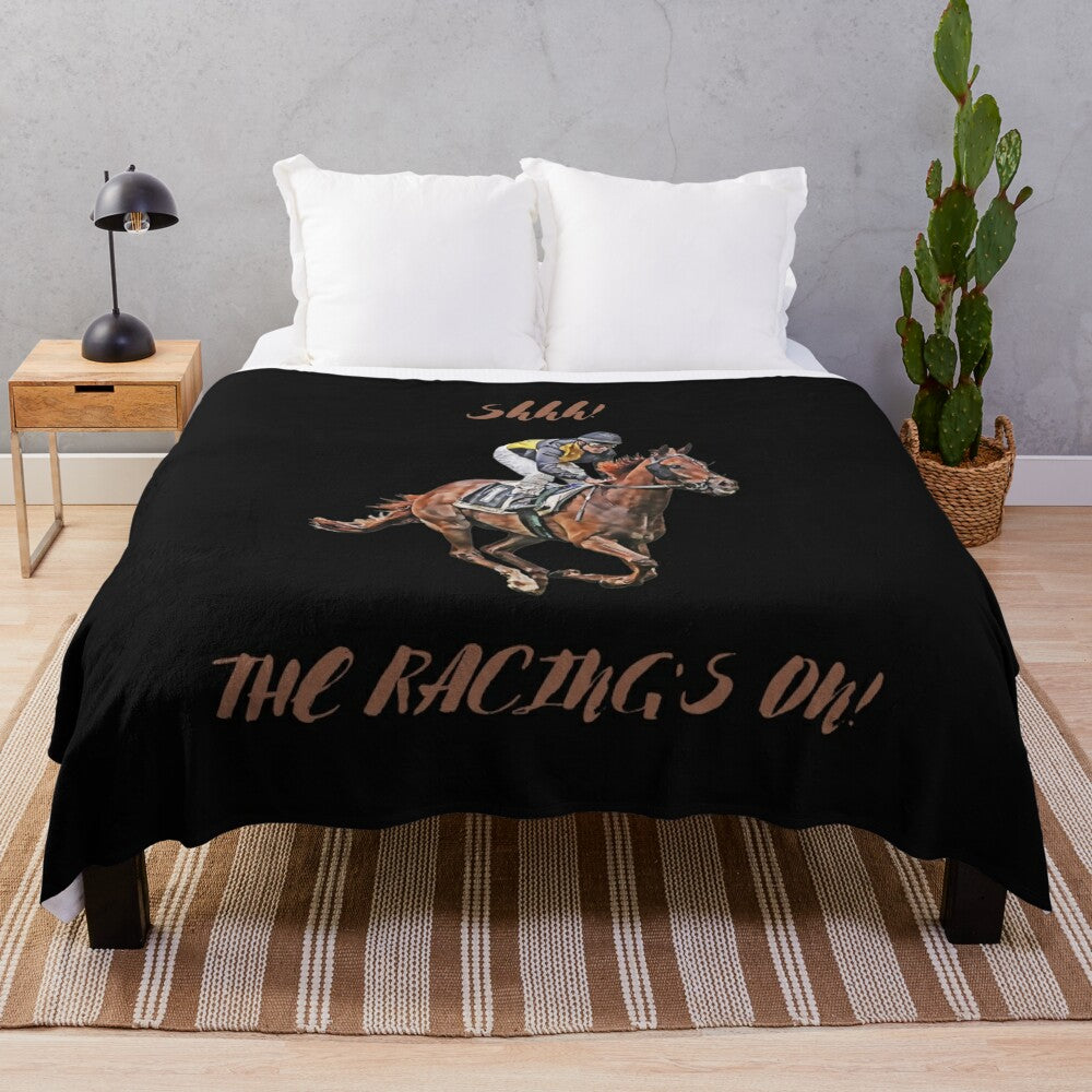 A plush blanket featuring a horse racing design