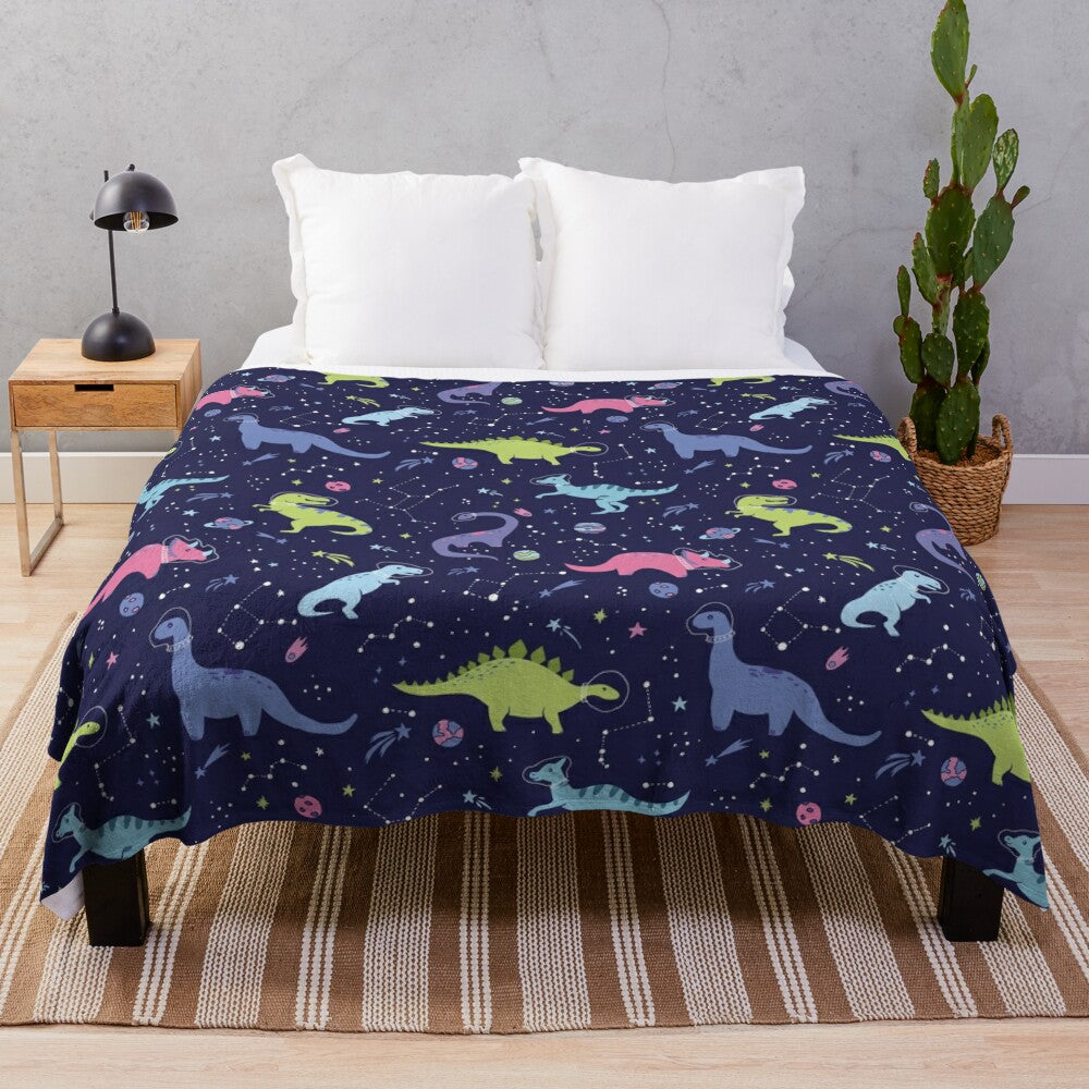 Colorful plush blanket featuring a pattern of space dinosaurs in a purple night sky with stars and constellations