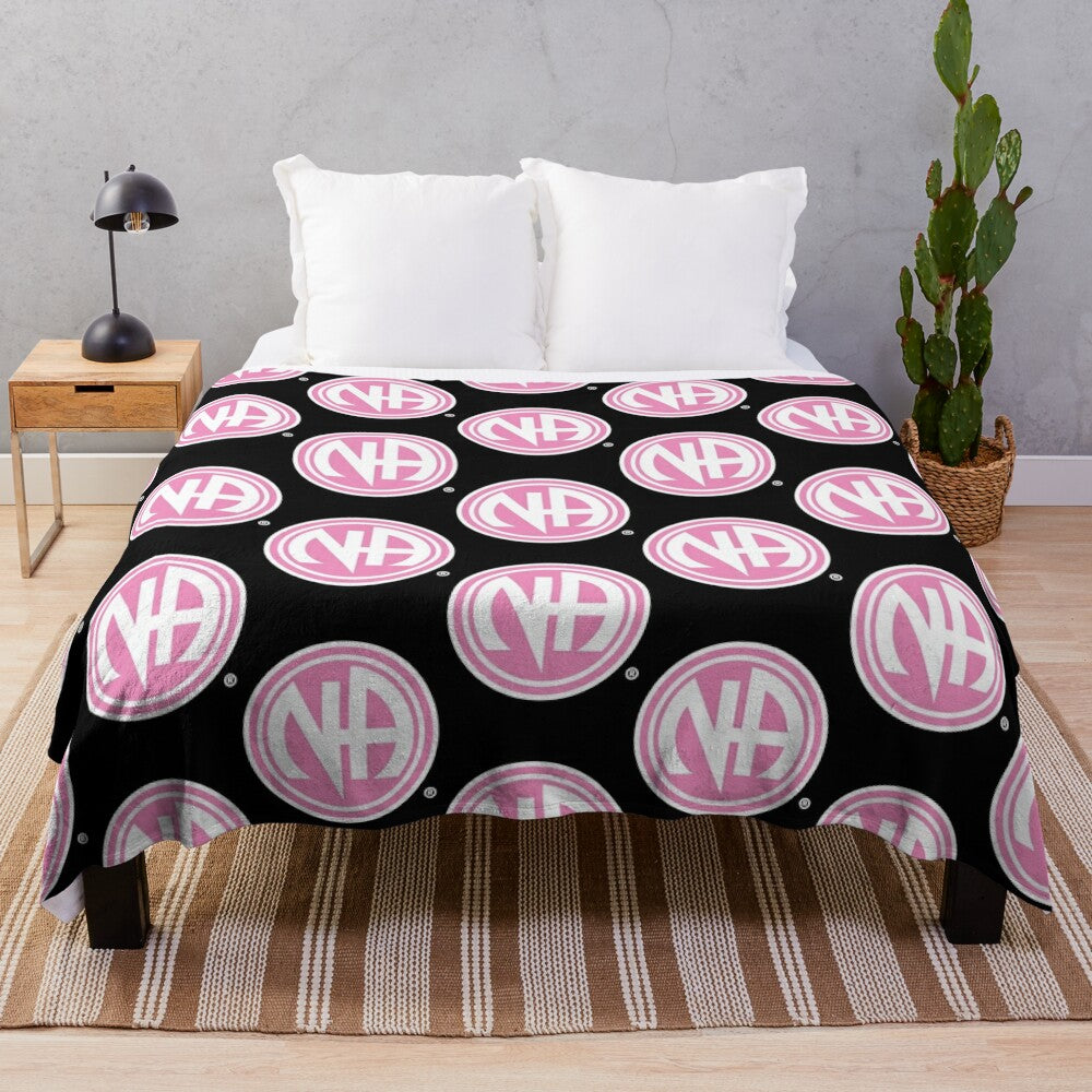 Pink plush blanket with Narcotics Anonymous and Alcoholics Anonymous logos