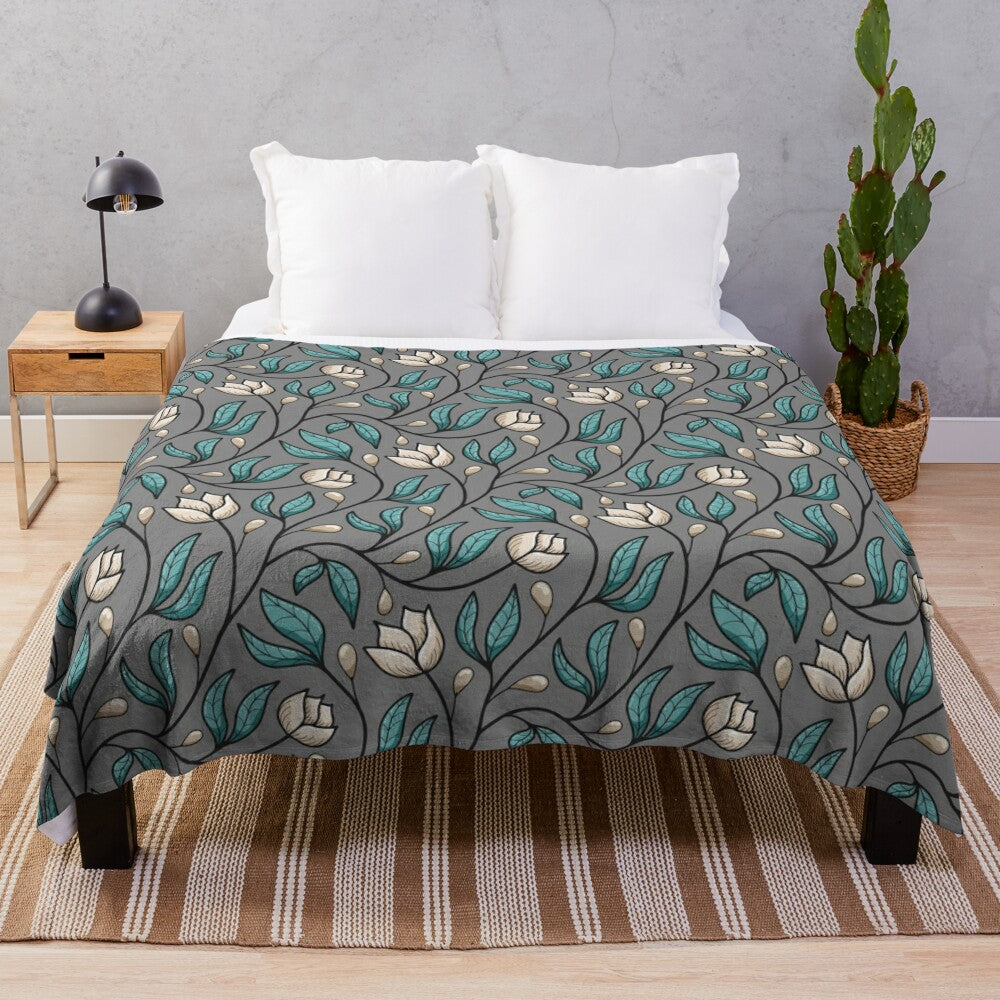 Floral plush blanket with botanical vine pattern in cream, teal, and grey colors