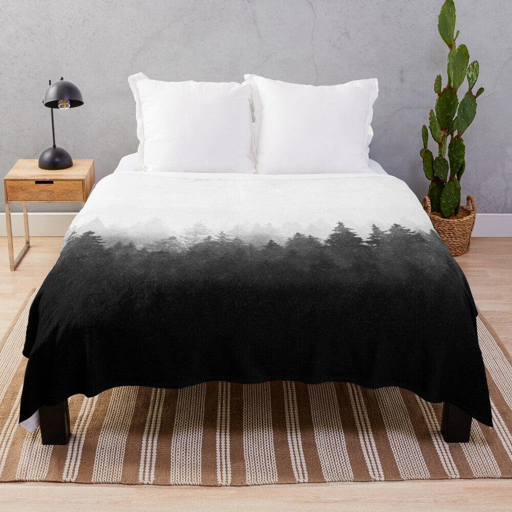 Plush blanket featuring a misty, romantic forest landscape with trees and cascading fog