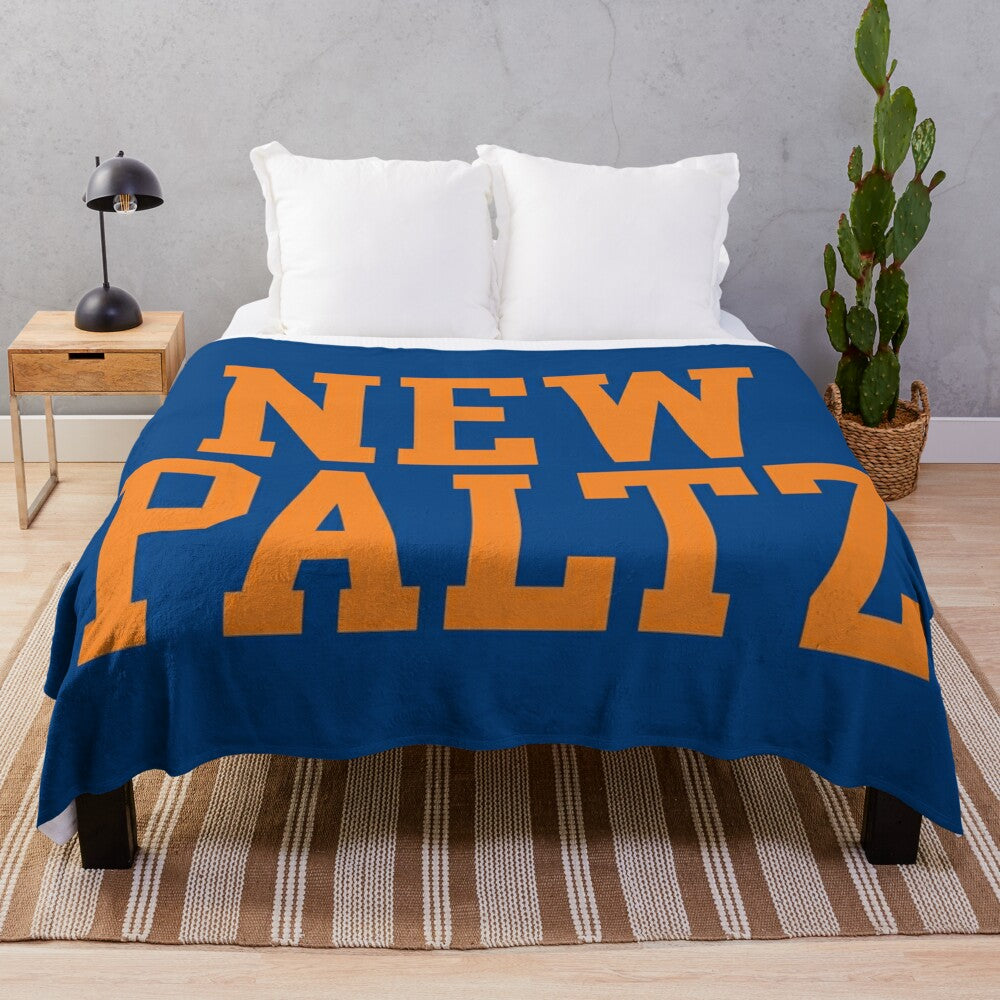 New Paltz college plush blanket with varsity-style curved text design