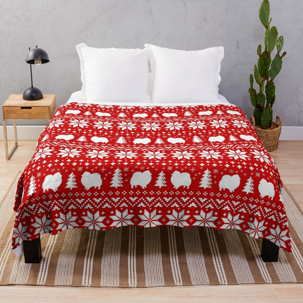 Pomeranian dog silhouettes on a red and white Christmas holiday pattern plush blanket