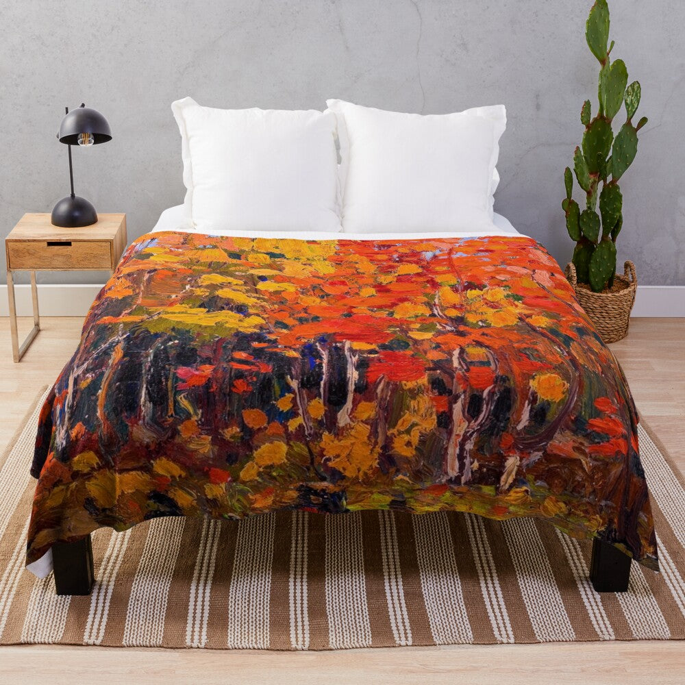 Plush blanket featuring the vibrant autumn woods artwork of Canadian painter Tom Thomson