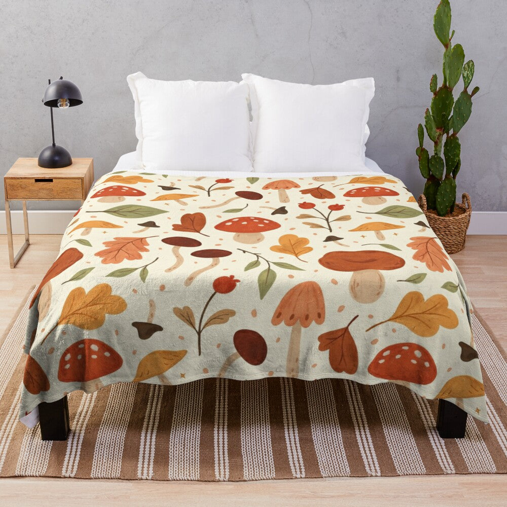 Soft plush blanket featuring a botanical pattern of mushrooms and fall leaves