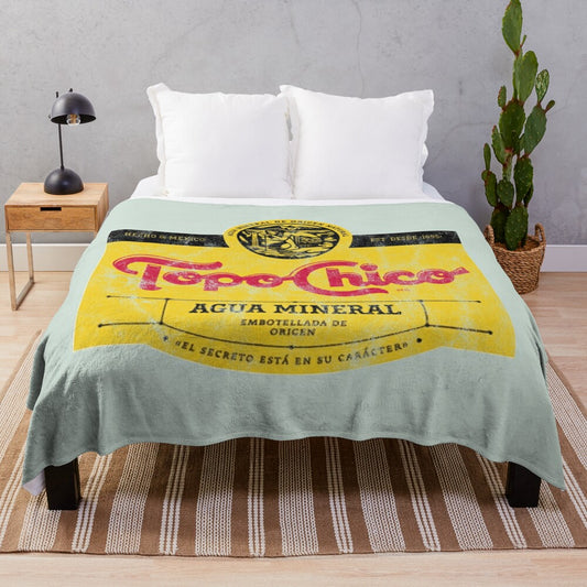 Topo Chico mineral water-inspired plush blanket with a worn, vintage design