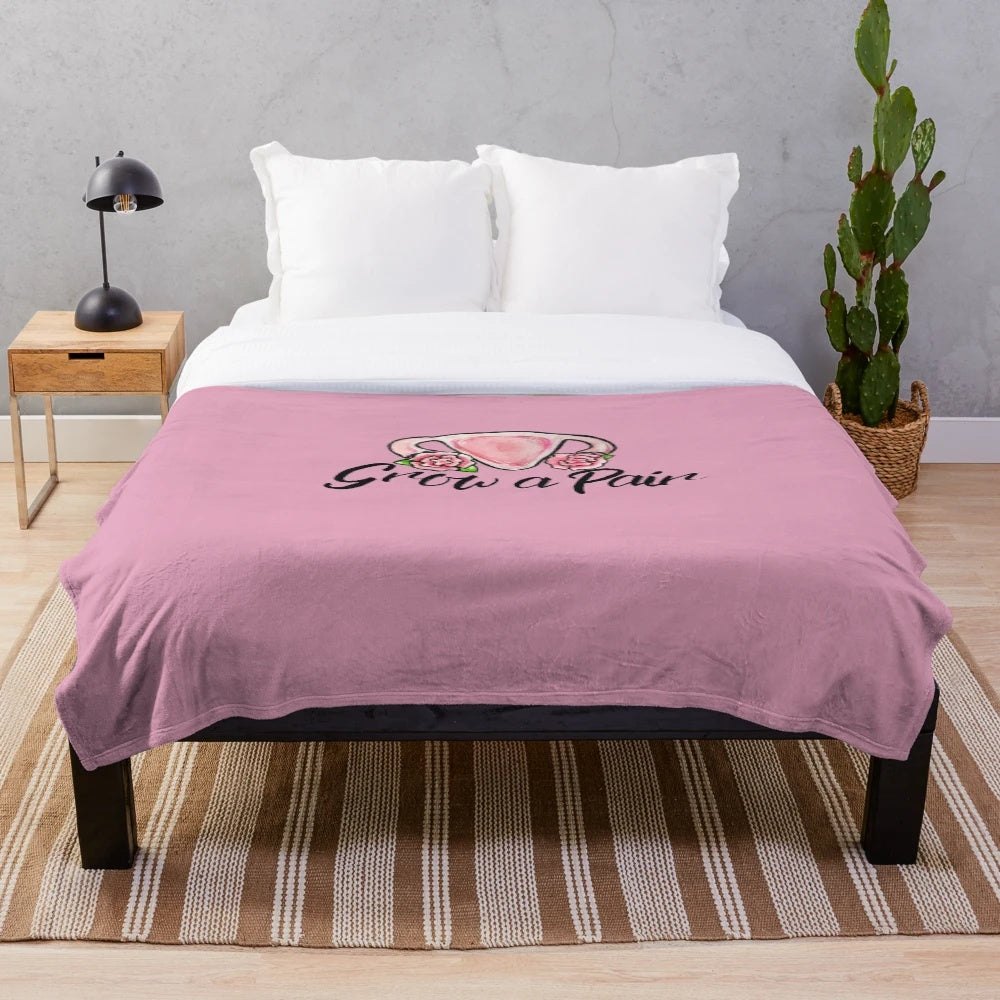 Soft and cozy plush blanket with uterus and flower design, perfect for feminist home decor