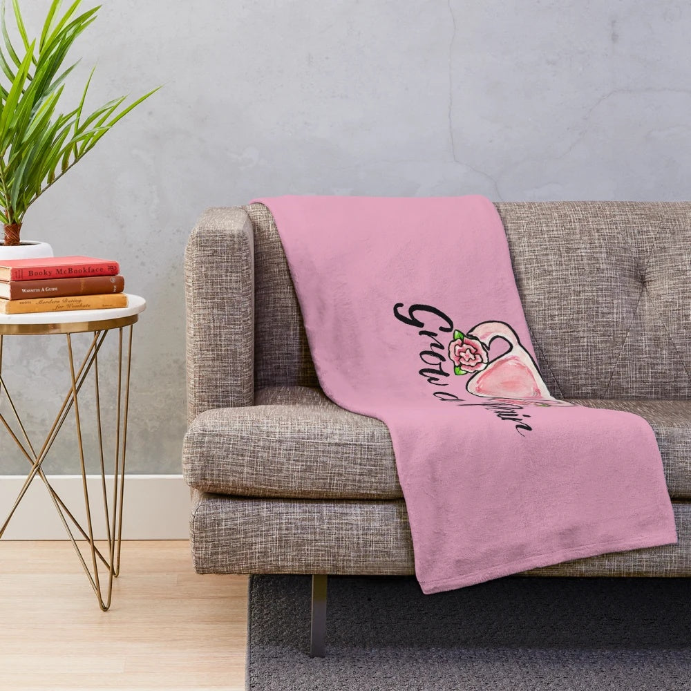 Soft and cozy plush blanket with uterus and flower design, perfect for feminist home decor