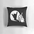 Photograph of a decorative pillow featuring a rabbit shadow hand making the 'Call You' hand sign from sign language.