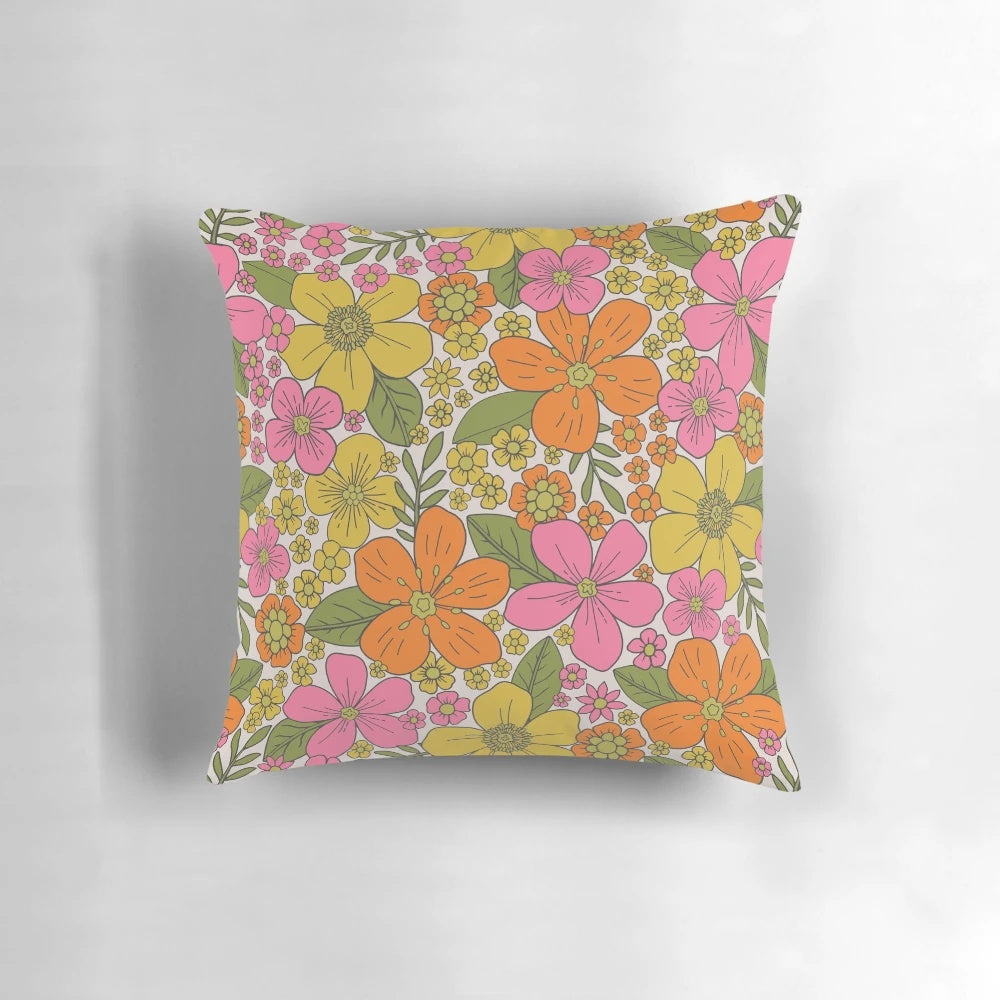 Colorful 1960s style floral throw pillow with pink, orange, and yellow flowers