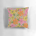 Colorful 1960s style floral throw pillow with pink, orange, and yellow flowers