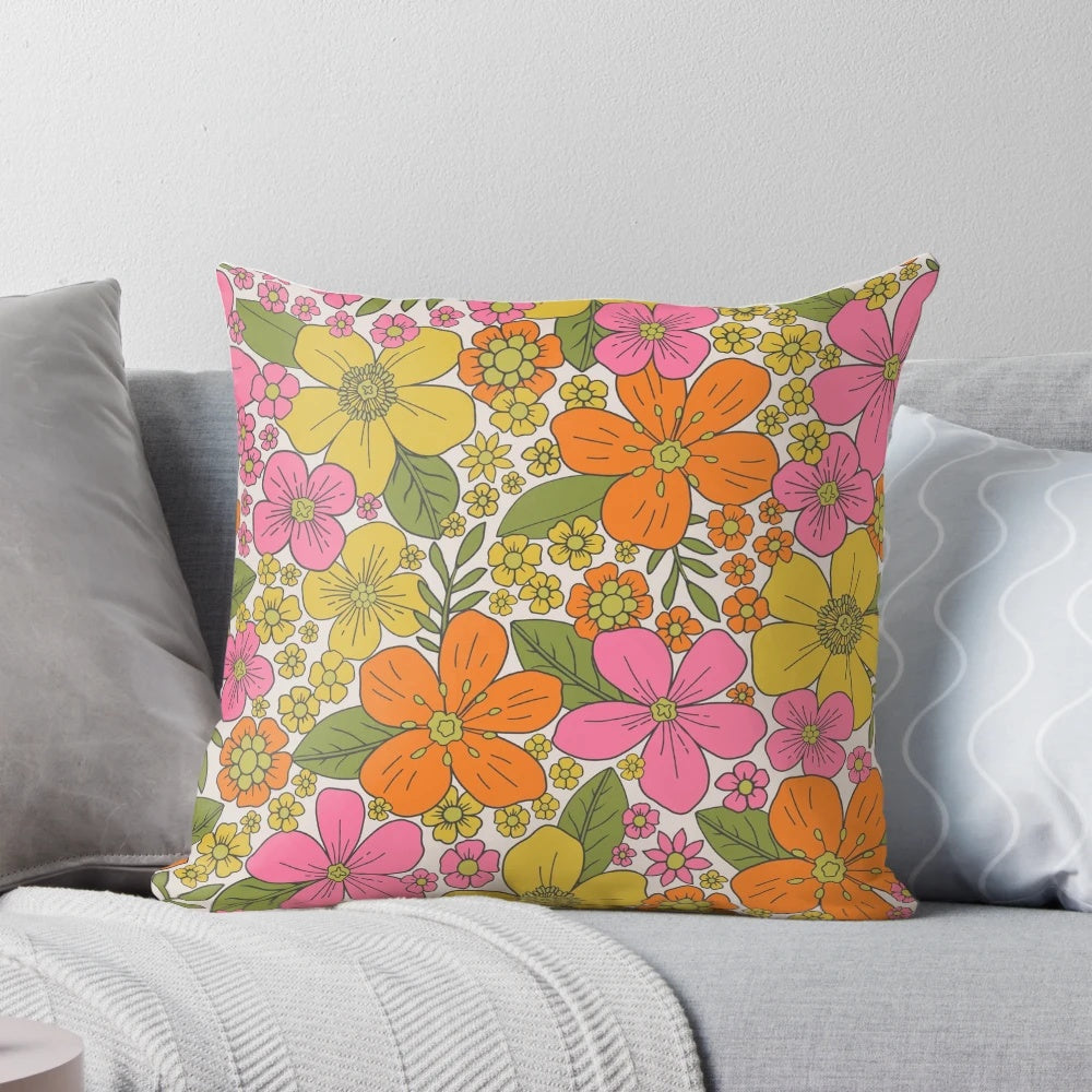Colorful 1960s style floral throw pillow with pink, orange, and yellow flowers