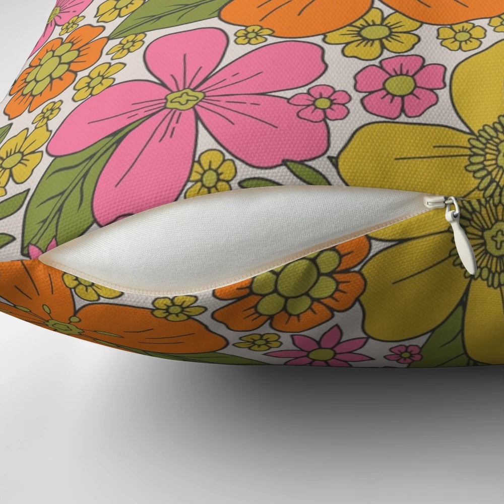 Colorful 1960s style floral throw pillow with pink, orange, and yellow flowers