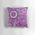 Colorful aboriginal art pattern in shades of pink adorns a plush throw pillow, perfect for creating a welcoming atmosphere in your home.
