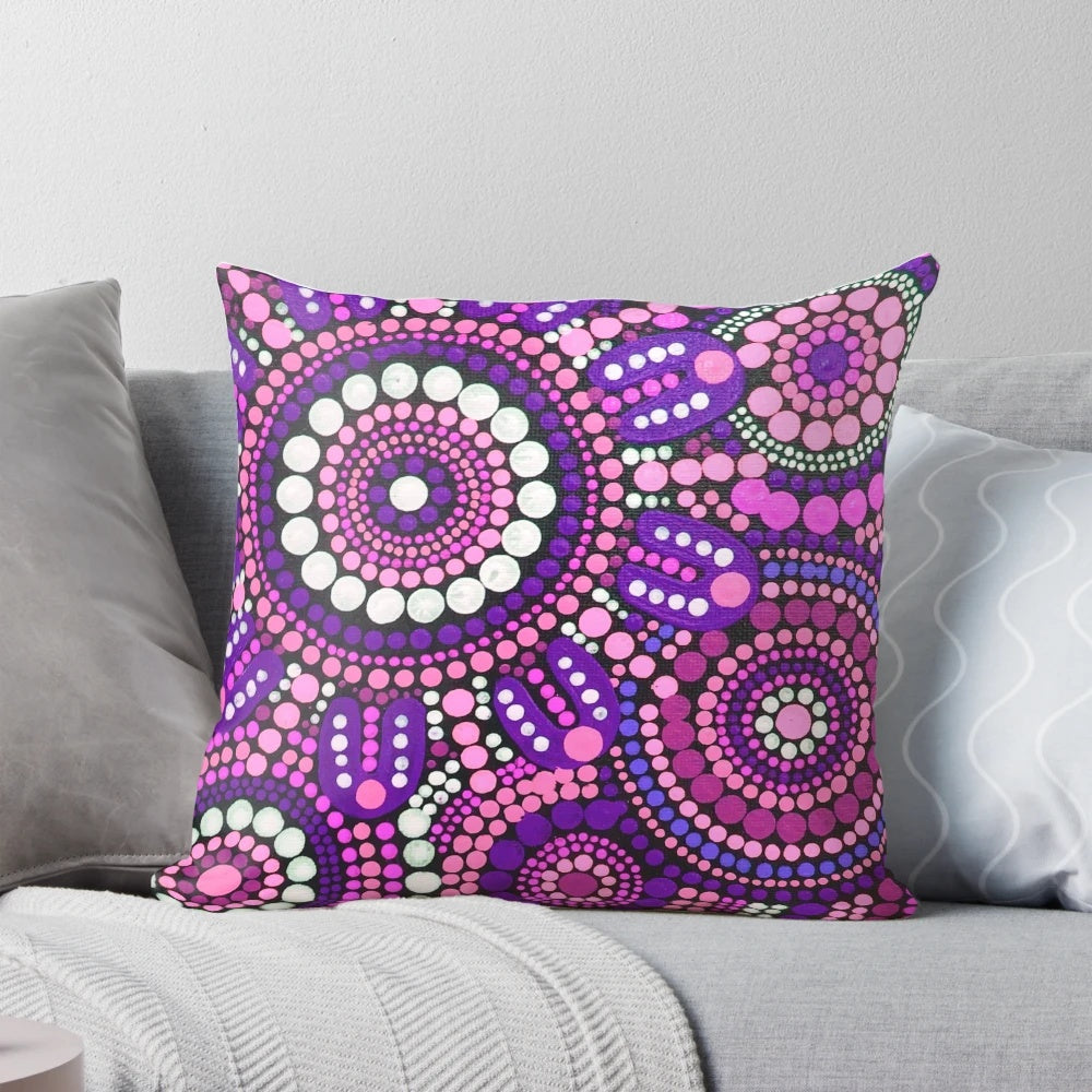 Colorful aboriginal art pattern in shades of pink adorns a plush throw pillow, perfect for creating a welcoming atmosphere in your home.