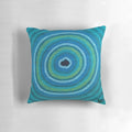 Vibrant blue pillow featuring an aboriginal-inspired waterhole design