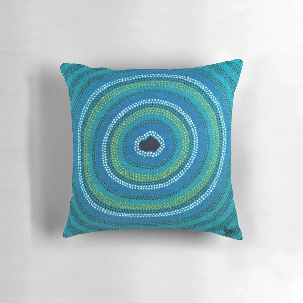 Vibrant blue pillow featuring an aboriginal-inspired waterhole design
