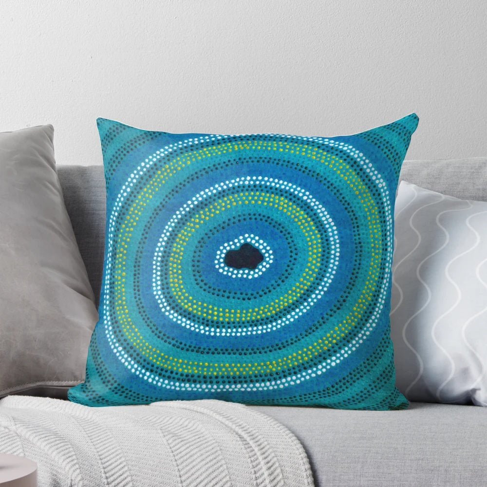 Vibrant blue pillow featuring an aboriginal-inspired waterhole design