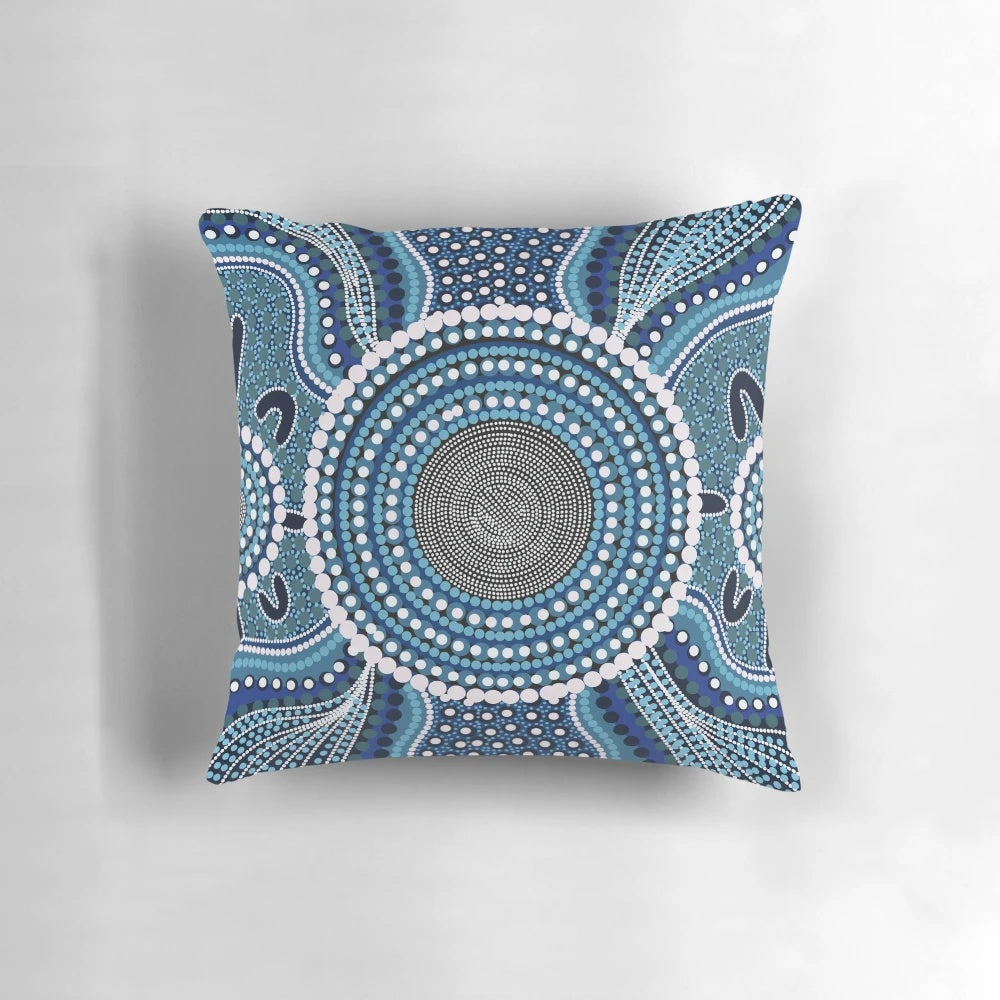 Colorful aboriginal dot painting design on a decorative throw pillow featuring an ocean theme.