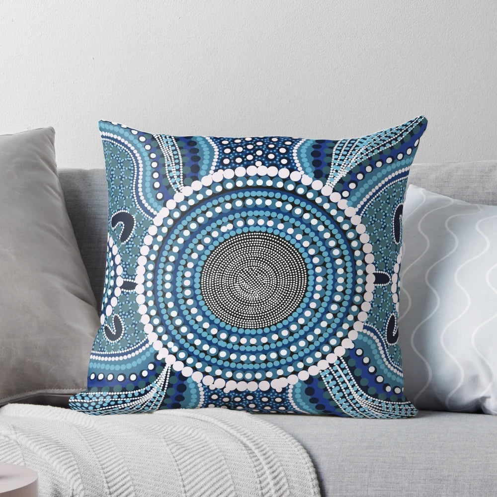 Colorful aboriginal dot painting design on a decorative throw pillow featuring an ocean theme.