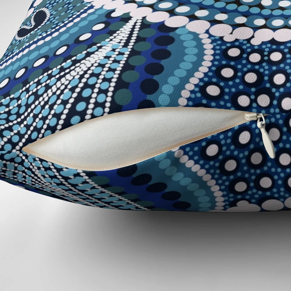 Colorful aboriginal dot painting design on a decorative throw pillow featuring an ocean theme.