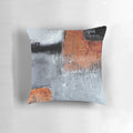 A modern abstract throw pillow in black and orange with a textured, geometric design