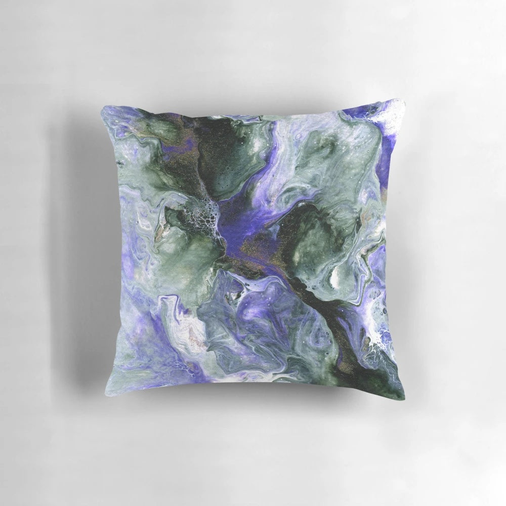 Colorful abstract fluid art decorative pillow featuring shades of purple, green, and gold.