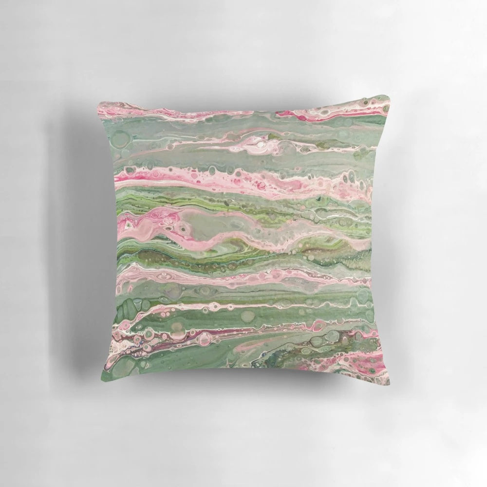 Colorful abstract art acrylic pour design on a decorative throw pillow in pink and green stripes.