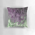 Colorful abstract art painting in purple and green tones on a modern throw pillow.