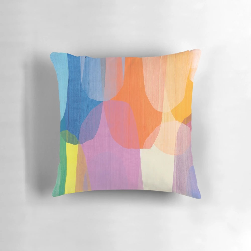 Colorful abstract art pillow featuring purple, blue, and tangerine tones designed by Canadian artist Claire Desjardins