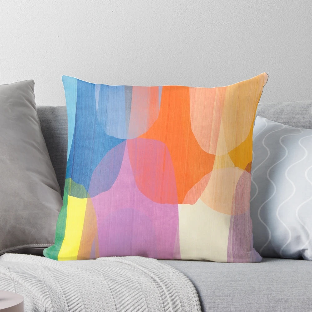 Colorful abstract art pillow featuring purple, blue, and tangerine tones designed by Canadian artist Claire Desjardins