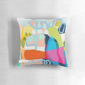 Colorful abstract art pillow in shades of red, pink, and fuchsia
