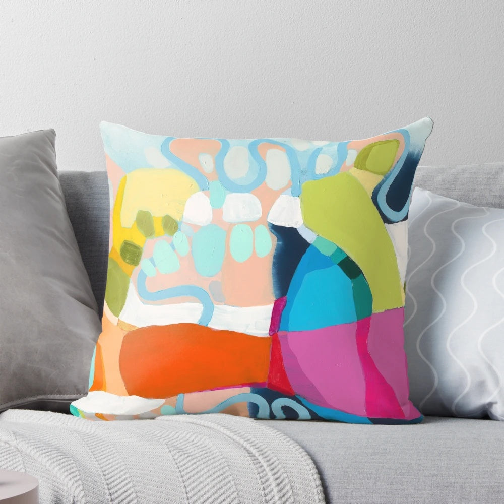 Colorful abstract art pillow in shades of red, pink, and fuchsia