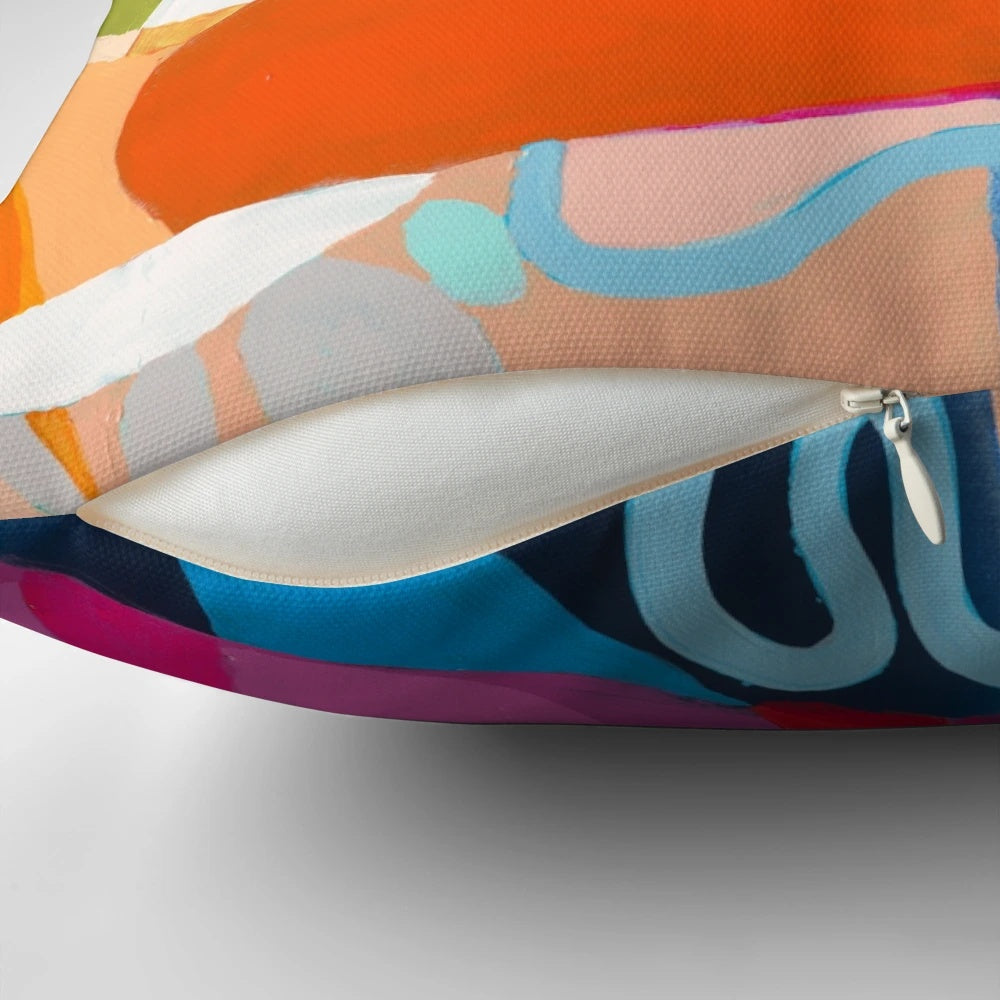 Colorful abstract art pillow in shades of red, pink, and fuchsia
