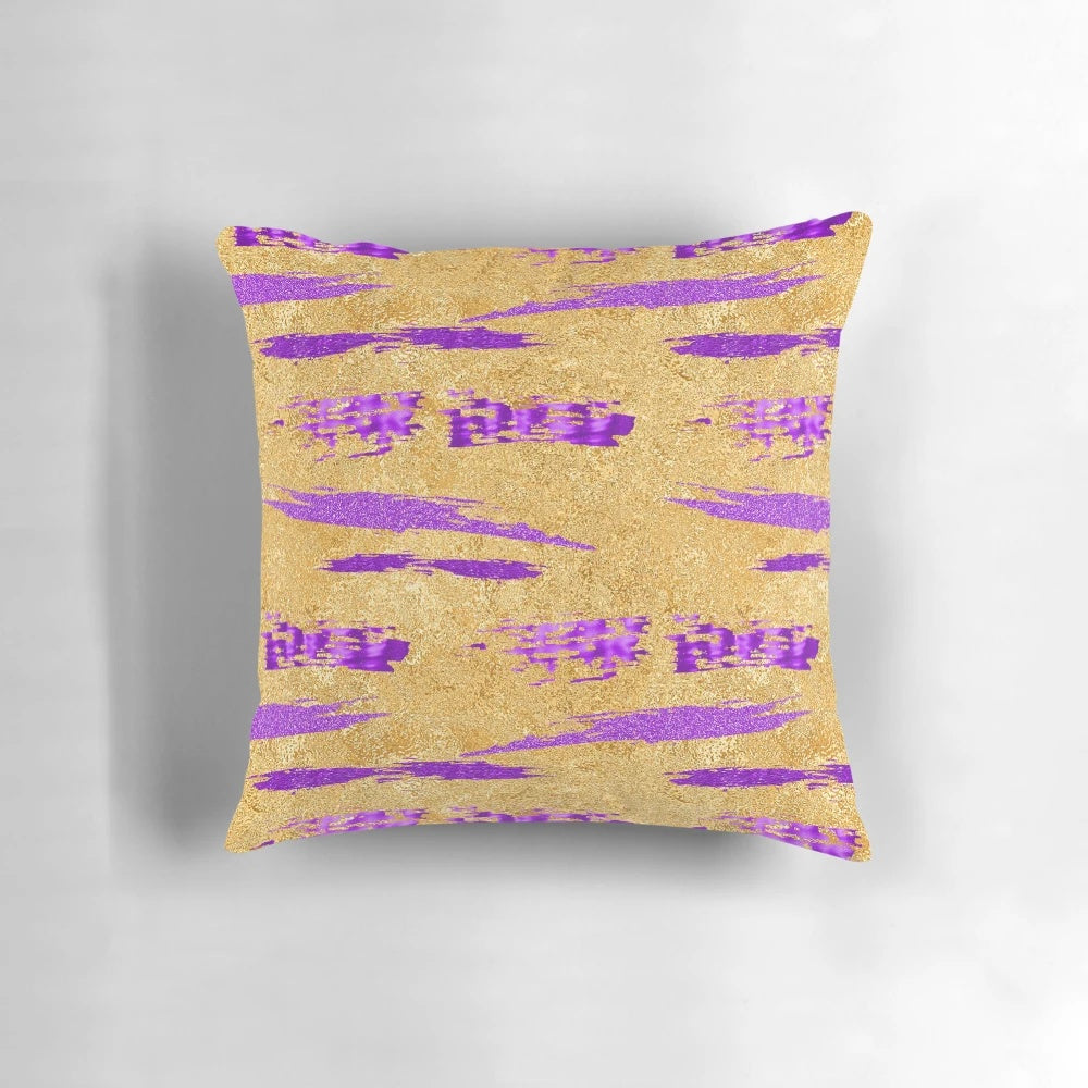 Stylish abstract art pillow in shimmering purple and gold tones, featuring a contemporary paint stroke design.