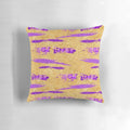 Stylish abstract art pillow in shimmering purple and gold tones, featuring a contemporary paint stroke design.