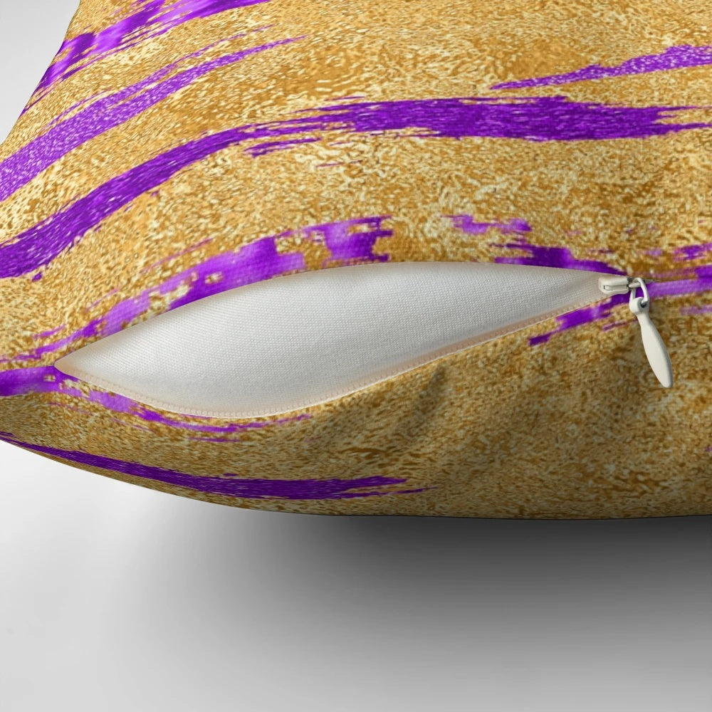 Stylish abstract art pillow in shimmering purple and gold tones, featuring a contemporary paint stroke design.
