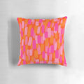 Colorful abstract art pillow with pink and orange painterly brush stroke design